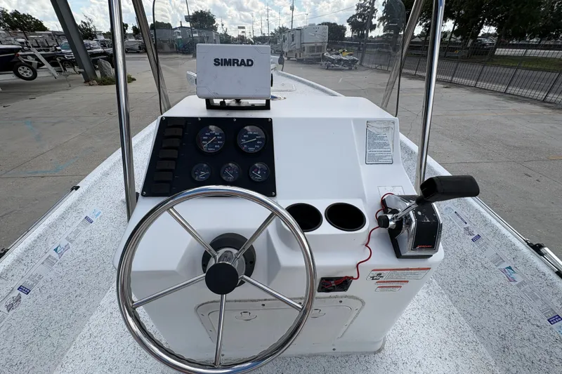 Slide: The Image of 2008 Kenner 19 VX boat console with steering wheel and Simrad navigation system. - 16