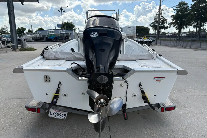Slide: The Image of 2008 Kenner 19 VX boat with outboard motor, parked on a trailer in a lot. - 5