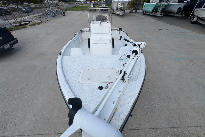 Slide: The Image of 2008 Kenner 19 VX boat on concrete lot, featuring trolling motor and center console. - 11