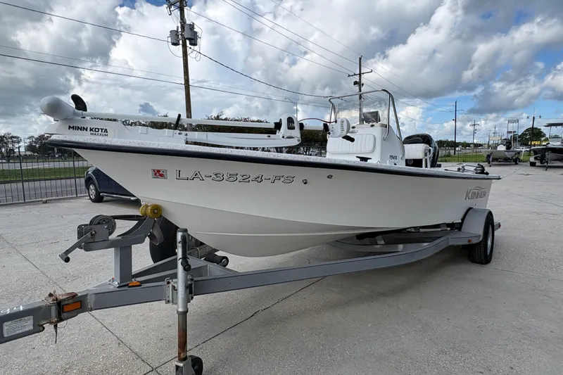 Slide: The Image of 2008 Kenner 19 VX boat on trailer with Minn Kota motor, parked outdoors. - 8