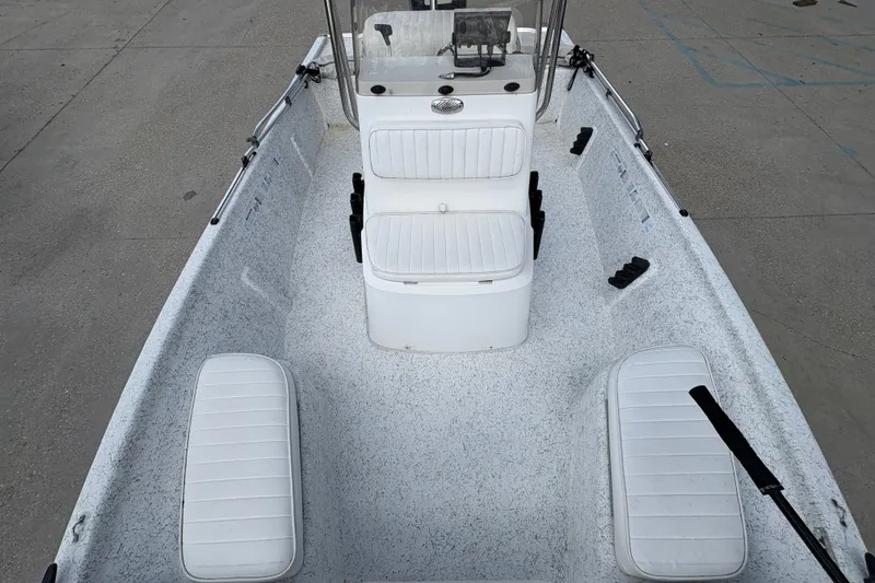 Slide: The Image of 2008 Kenner 19 VX boat interior with white seating and console, viewed from above. - 21
