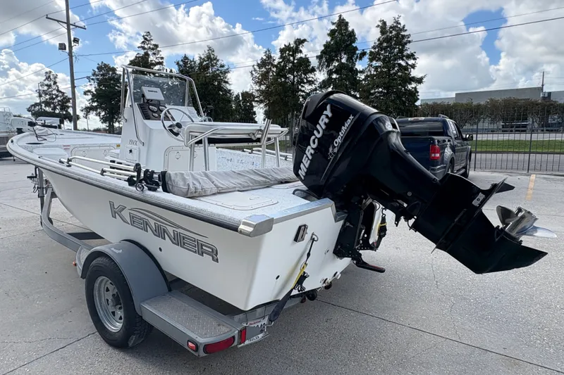 Slide: The Image of 2008 Kenner 19 VX boat with Mercury engine on trailer, parked outdoors. - 6