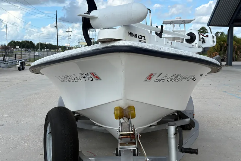 Slide: The Image of 2008 Kenner 19 VX boat on trailer with Minn Kota motor, parked outdoors. - 9