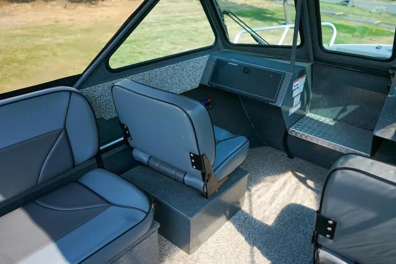 Slide: The Image of Interior of 2020 Alumaweld Blackhawk 180 boat with gray seating and dashboard. - 13