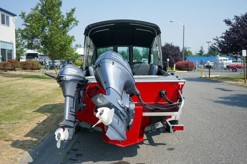 Slide: The Image of 2020 Alumaweld Blackhawk 180 boat with dual Yamaha outboard motors, parked outdoors. - 4