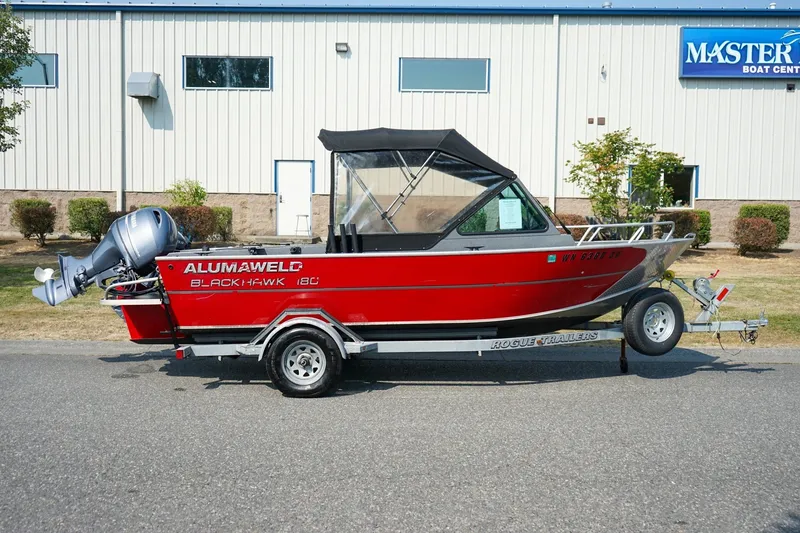 Slide: The Image of 2020 Alumaweld Blackhawk 180 boat on trailer, parked outside Master Marine Boat Center. - 2