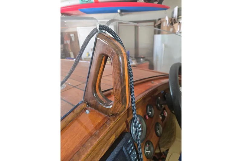 Slide: The Image of Wooden dashboard of a 2025 Custom Line 17 boat with gauges and rope detail. - 18