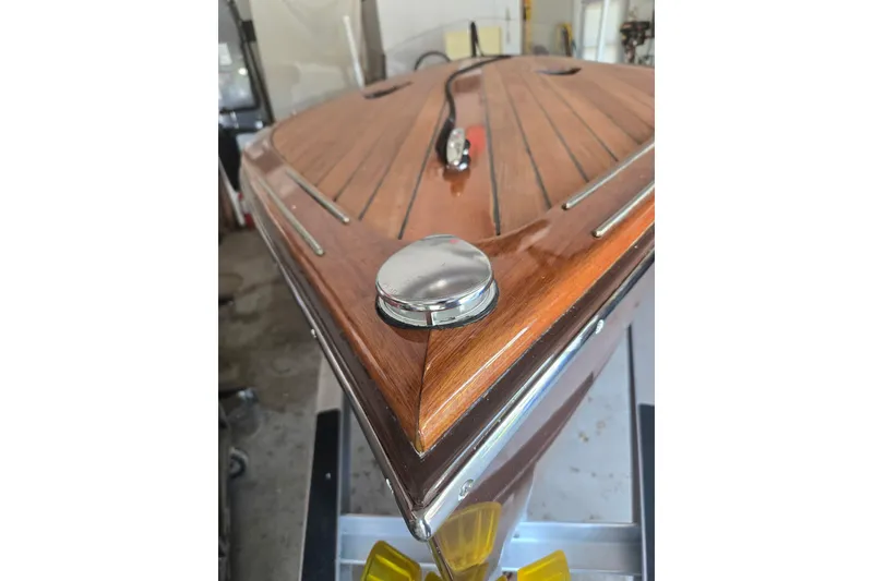Slide: The Image of Custom Line 17 boat, 2025 model, featuring polished wood deck and chrome details. - 15