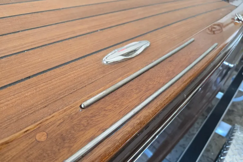 Slide: The Image of Polished wooden deck of Custom Line 17, 2025 model, featuring sleek metal accents. - 20