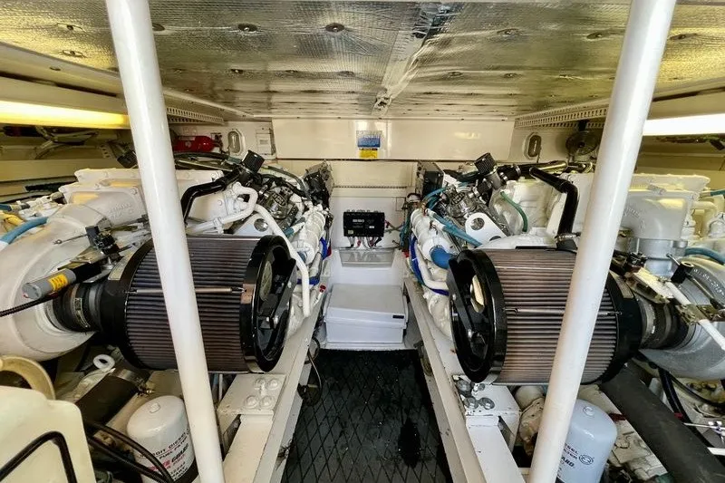 Slide: The Image of Engine room of a 1998 Viking 43 Open yacht, showcasing dual engines and mechanical components. - 19