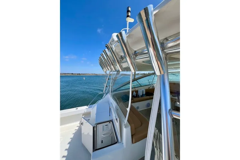 Slide: The Image of 1998 Viking 43 Open yacht with rod holders, docked on a sunny day. - 10