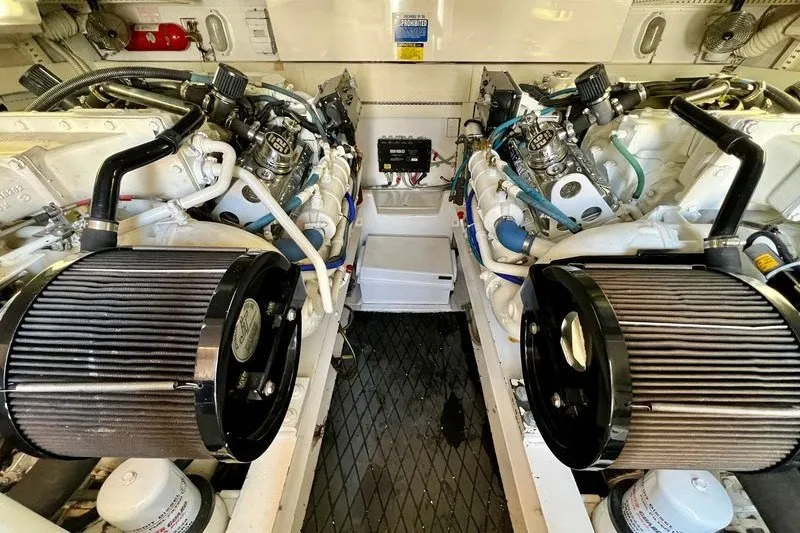 Slide: The Image of Engine room of a 1998 Viking 43 Open boat, showcasing dual engines and components. - 17
