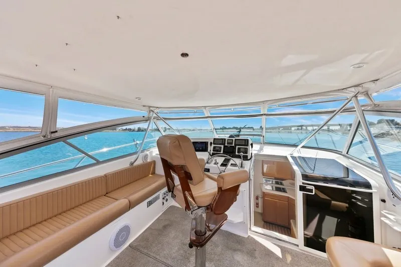 Slide: The Image of Interior view of a 1998 Viking 43 Open yacht, featuring a spacious helm and seating area. - 7