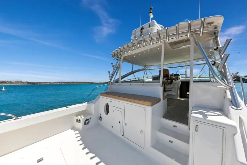 Slide: The Image of 1998 Viking 43 Open yacht with spacious deck and clear blue water backdrop. - 9