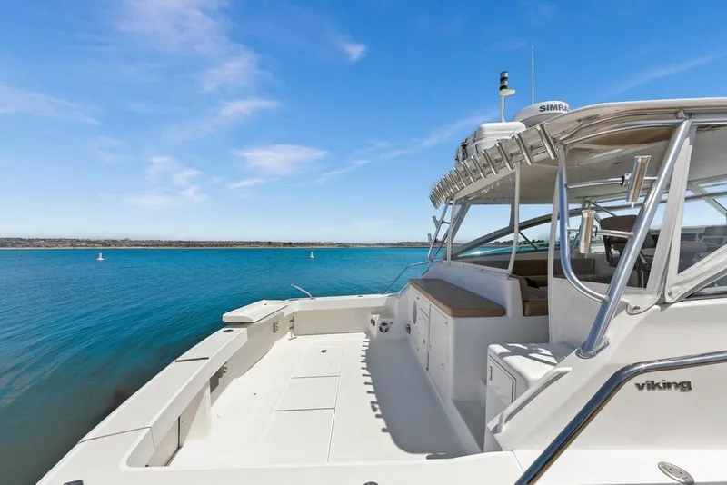 Slide: The Image of 1998 Viking 43 Open yacht on serene blue waters under a clear sky. - 8
