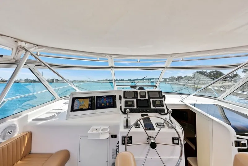 Slide: The Image of Cockpit view of 1998 Viking 43 Open yacht with navigation equipment and scenic waterway. - 5