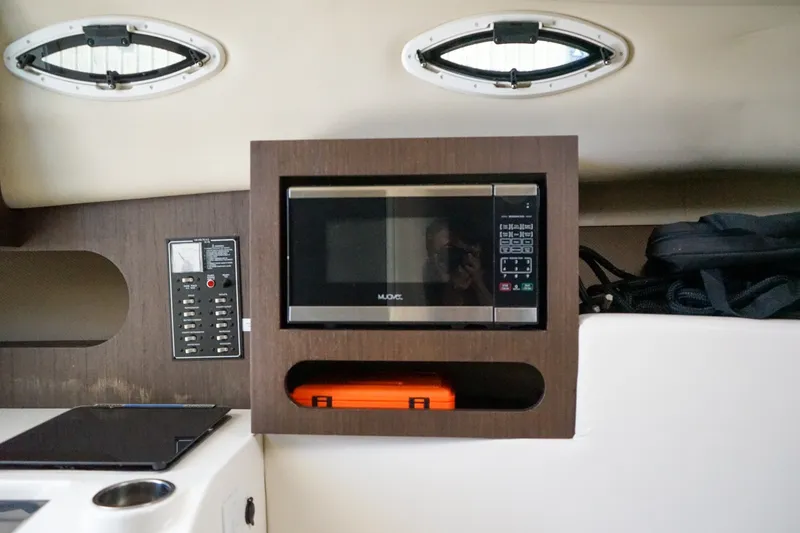 Slide: The Image of 2019 Striper 270 Walkaround interior with microwave and control panel. - 15