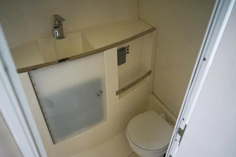 Slide: The Image of 2019 Striper 270 Walkaround boat bathroom with sink and toilet. - 17