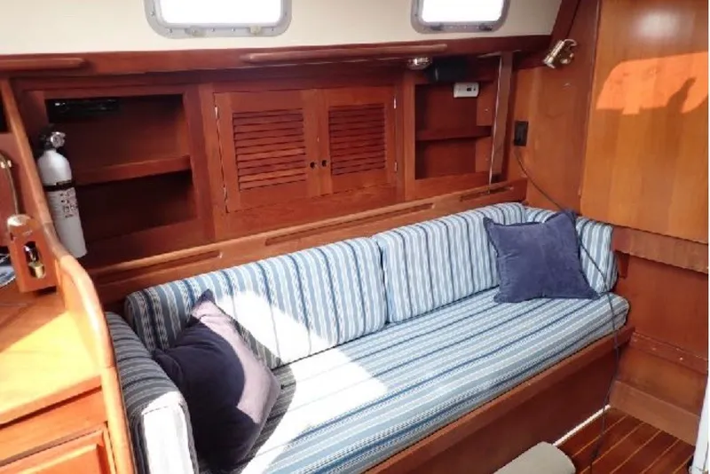 Slide: The Image of Interior of 1987 Tartan 34-2 sailboat with striped cushions and wooden cabinetry. - 6