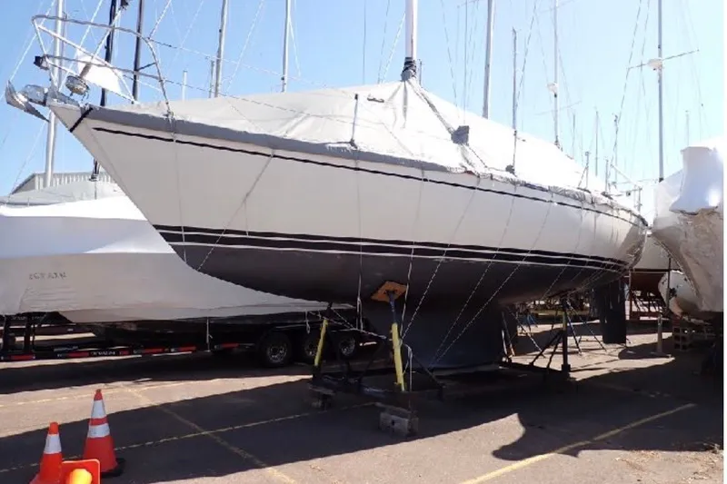Slide: The Image of 1987 Tartan 34-2 sailboat on trailer in marina, covered and ready for transport. - 4