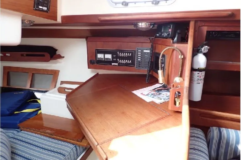 Slide: The Image of Interior of a 1987 Tartan 34-2 sailboat with navigation equipment and wooden cabinetry. - 8