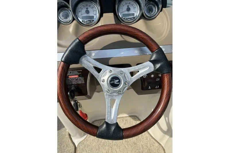 Slide: The Image of Steering wheel of 2010 Sea Ray 260 Sundeck boat with gauges in background. - 16