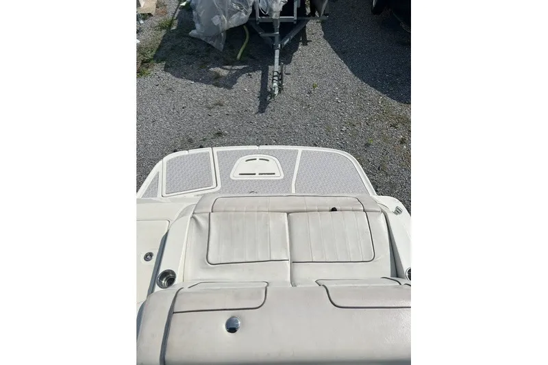 Slide: The Image of 2010 Sea Ray 260 Sundeck boat interior with cushioned seating and deck view. - 13