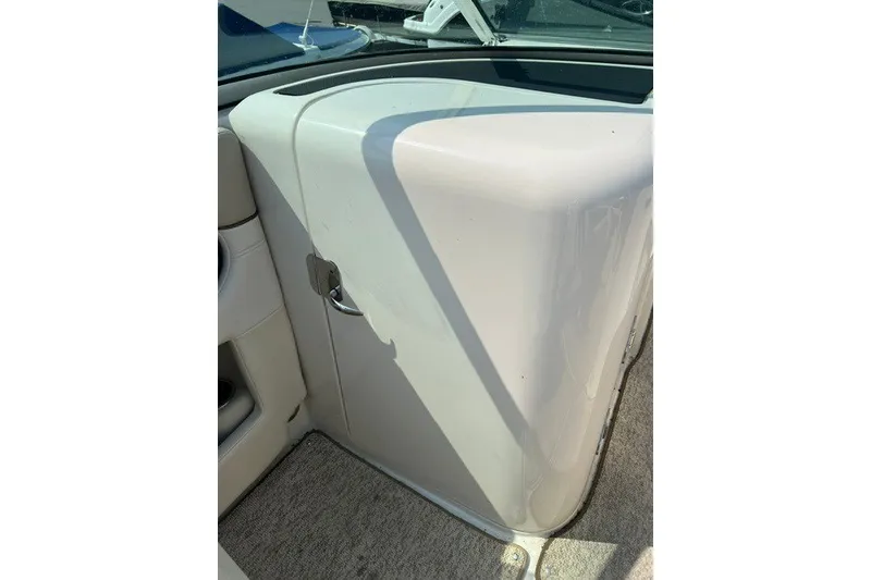 Slide: The Image of 2010 Sea Ray 260 Sundeck interior detail, featuring white panel and carpeted flooring. - 19
