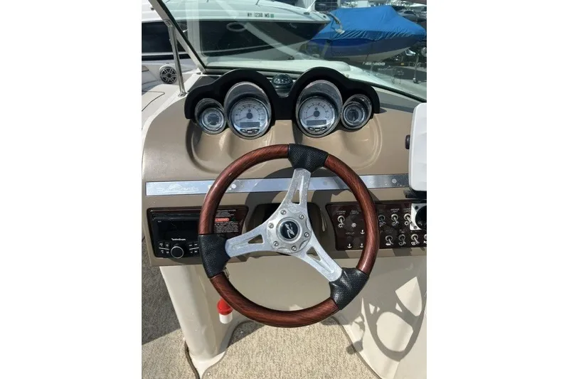 Slide: The Image of Steering wheel and dashboard of 2010 Sea Ray 260 Sundeck boat. - 17