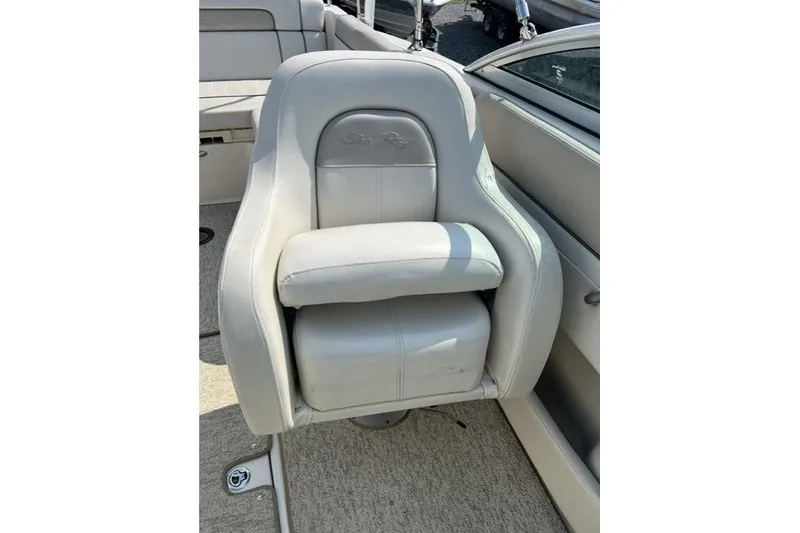 Slide: The Image of Captain's seat on 2010 Sea Ray 260 Sundeck boat, featuring plush white upholstery. - 14