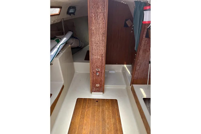 Slide: The Image of Interior of a 1984 S2 6.9 sailboat, featuring wooden paneling and compact cabin space. - 10