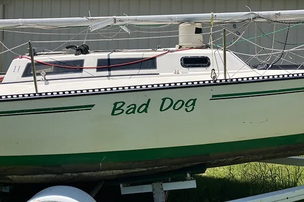 Slide: The Image of 1984 S2 6.9 sailboat named "Bad Dog" on trailer, side view. - 3