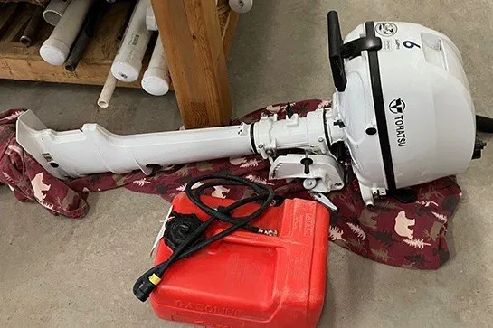 Slide: The Image of 1984 S2 6.9 outboard motor with red fuel tank on garage floor. - 7