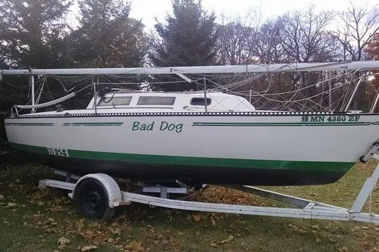 Slide: The Image of Sailboat "Bad Dog" on trailer, S2 6.9 model, 1984, parked on grass. - 2