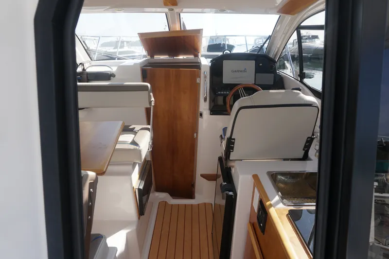 Slide: The Image of Interior of a 2018 Cutwater C-24 boat with modern helm and seating. - 38