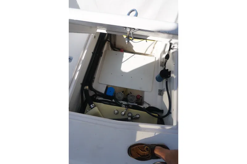 Slide: The Image of 2018 Cutwater C-24 boat compartment with visible gauges and wiring. - 40