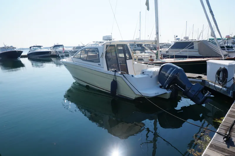 Slide: The Image of 2018 Cutwater C-24 boat docked in a marina with other vessels. - 14