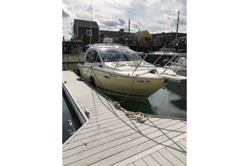 Slide: The Image of 2018 Cutwater C-24 boat docked at marina under cloudy sky. - 3