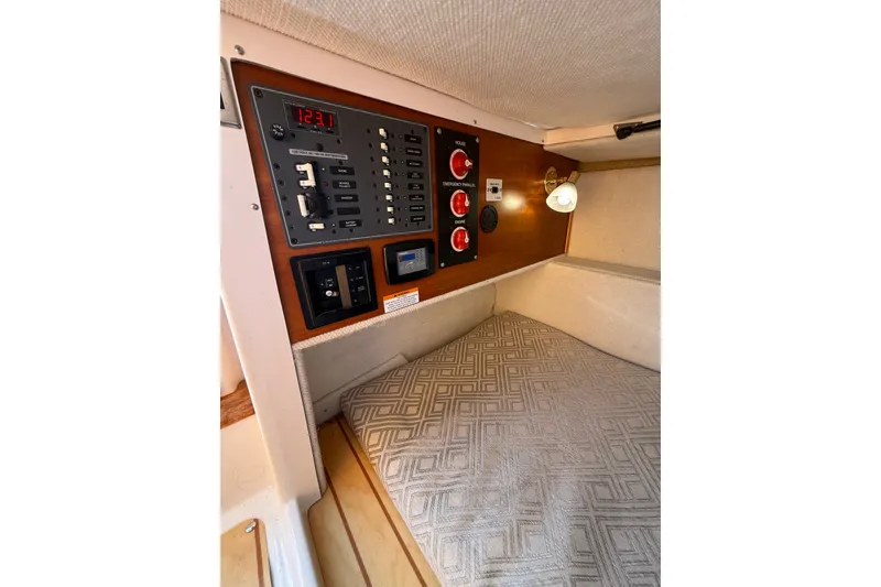 Slide: The Image of 2018 Cutwater C-24 cabin interior with control panel and cozy sleeping area. - 8