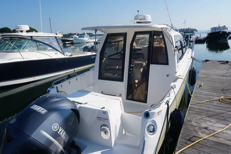 Slide: The Image of 2018 Cutwater C-24 boat docked, featuring Yamaha 300 engine, sunny marina setting. - 15