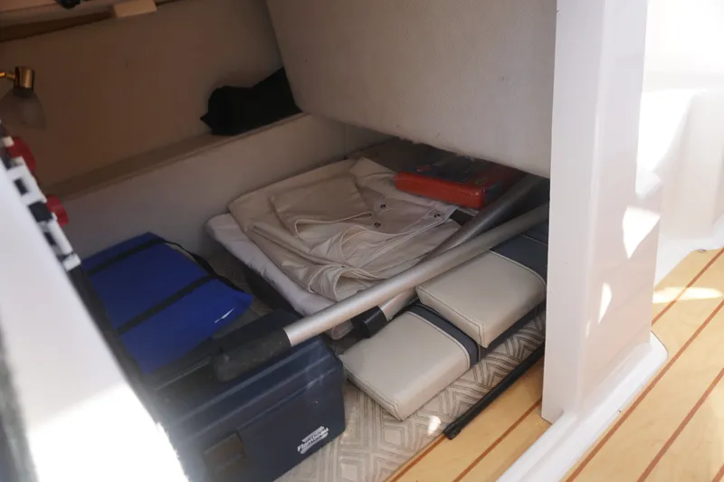 Slide: The Image of Storage compartment in a 2018 Cutwater C-24 boat with various equipment and supplies. - 33
