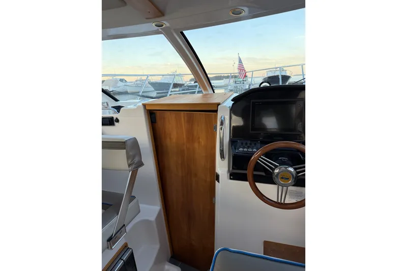 Slide: The Image of Interior view of 2018 Cutwater C-24 boat cockpit with steering wheel and control panel. - 5