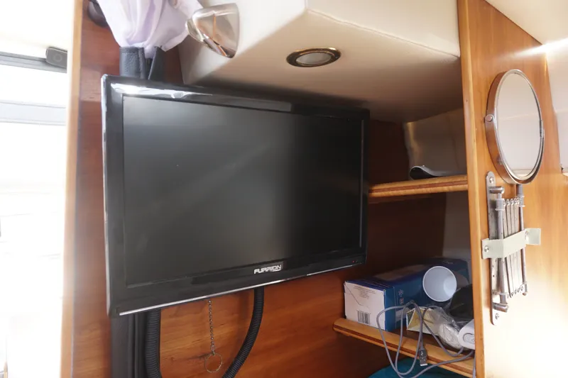 Slide: The Image of Interior of 2018 Cutwater C-24 boat with mounted TV and storage shelves. - 30