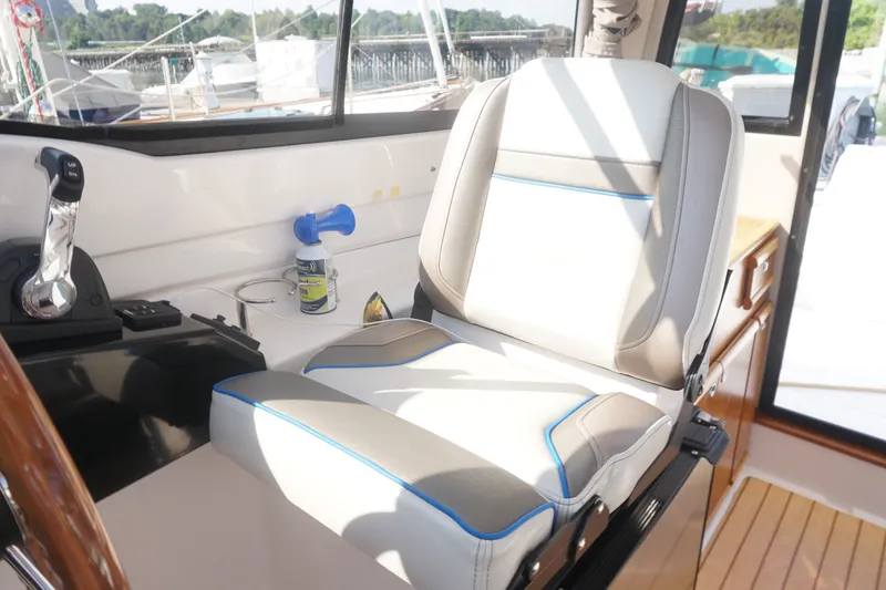 Slide: The Image of Captain's seat in a 2018 Cutwater C-24 boat cockpit, featuring controls and accessories. - 31