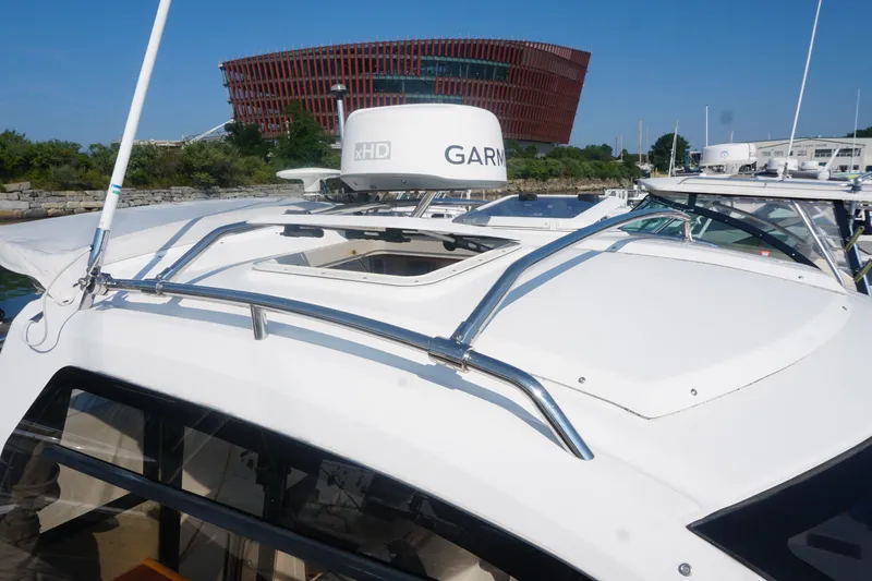 Slide: The Image of 2018 Cutwater C-24 boat with Garmin radar, docked near modern architecture. - 20