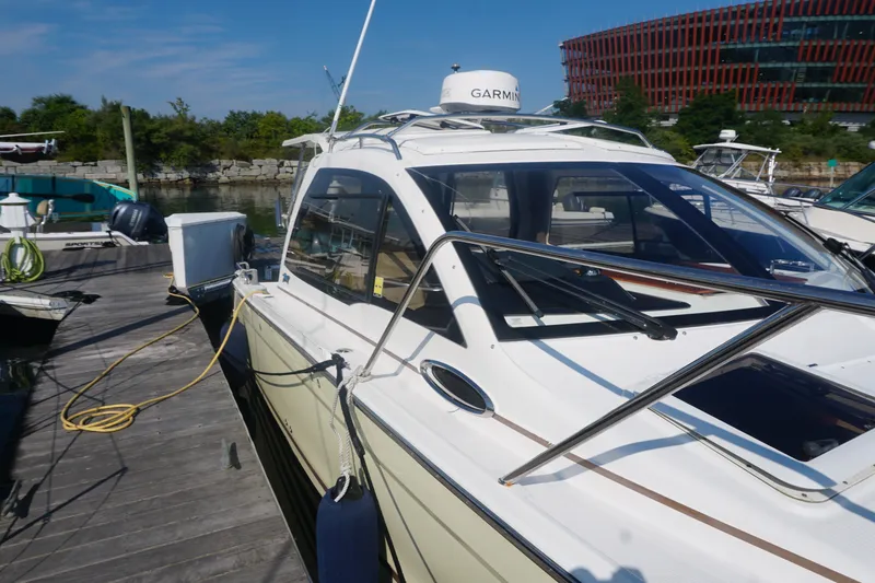Slide: The Image of 2018 Cutwater C-24 boat docked, featuring Garmin equipment and sleek design. - 18