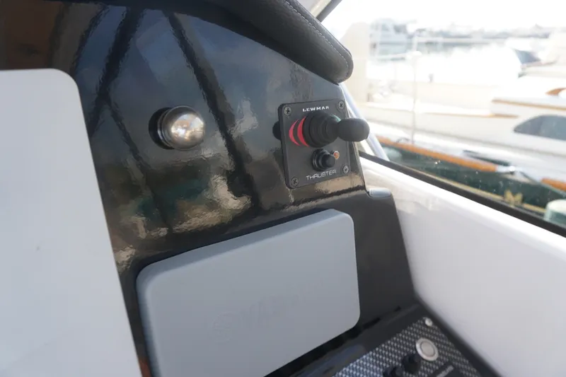 Slide: The Image of Control panel of a 2018 Cutwater C-24 boat featuring a Lewmar thruster switch. - 25