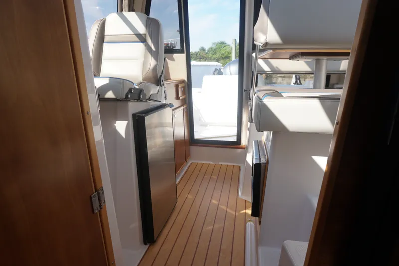 Slide: The Image of Interior view of 2018 Cutwater C-24 boat, featuring seating and wooden flooring. - 28