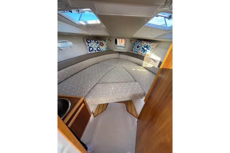 Slide: The Image of Interior of 2018 Cutwater C-24 boat with cozy cabin and patterned cushions. - 12