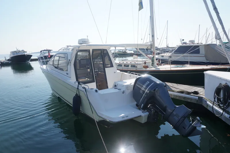 Slide: The Image of 2018 Cutwater C-24 boat docked in marina, featuring Yamaha outboard motor. - 43